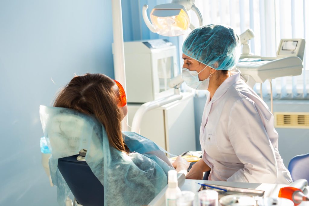 Dentist examining teeth of patient